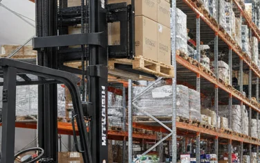 Mitsubishi forklifts in an industrial warehouse setting - diesel and electric models
