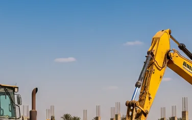 Heavy construction equipment at work in Egypt - bulldozer and excavator on desert construction site