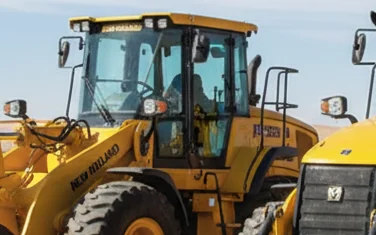 New Holland Construction yellow heavy equipment on a job site in Egypt